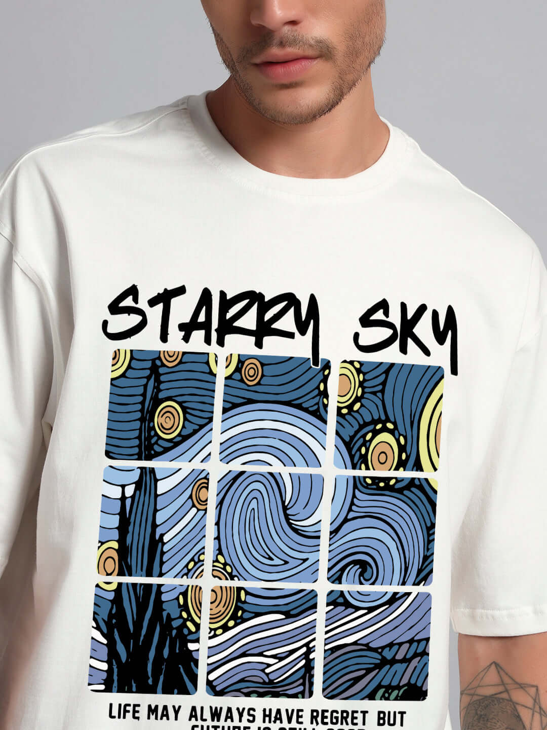 Man wearing starry sky oversized T-shirt with artistic graphic in off white.
