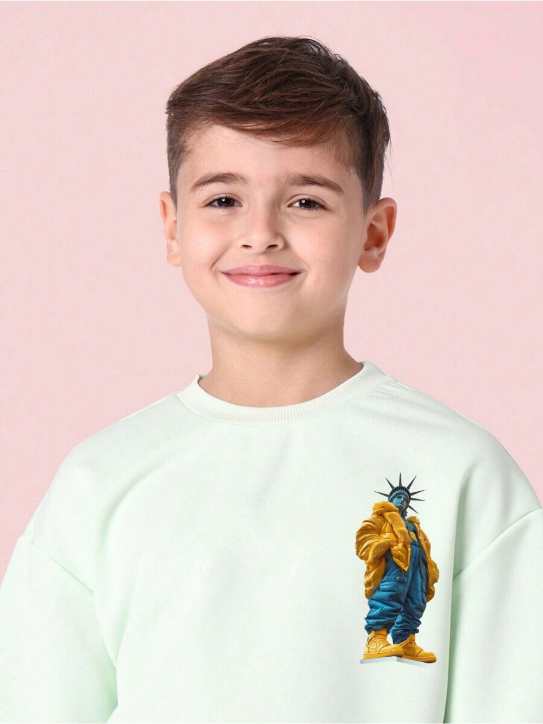 Boy wearing STATUE OF LIBERTY CO-ORD SET FOR BOYS AND GIRLS MINT GREEN with statue print on sweatshirt.