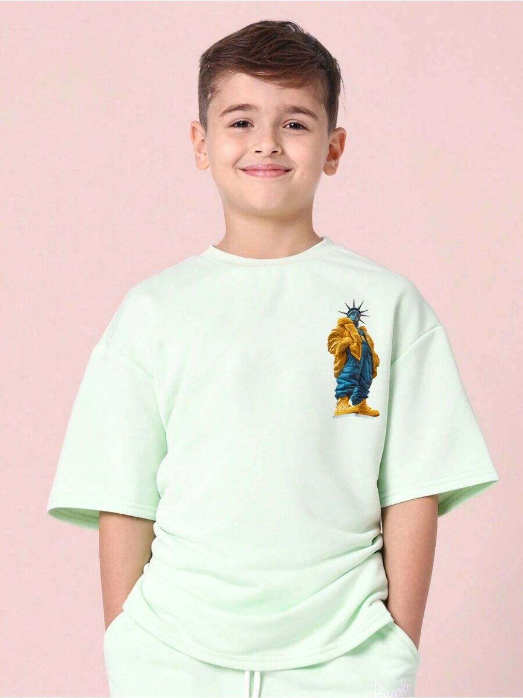 Boy wearing STATUE OF LIBERTY T-SHIRT FOR BOYS GIRLS MINT GREEN with artistic Liberty print, symbolizing freedom and style.