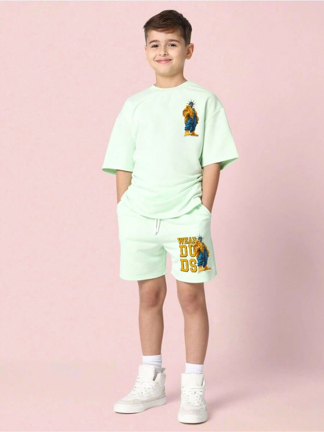 Child wearing STATUE OF LIBERTY CO-ORD SET FOR BOYS AND GIRLS MINT GREEN outfit with Statue of Liberty design on pastel pink background.