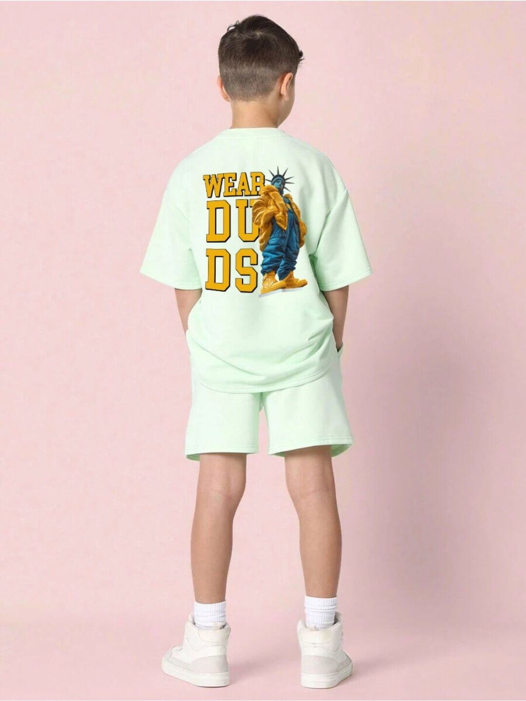 Kid wearing STATUE OF LIBERTY CO-ORD SET FOR BOYS AND GIRLS MINT GREEN with graphic shirt design, rear view.