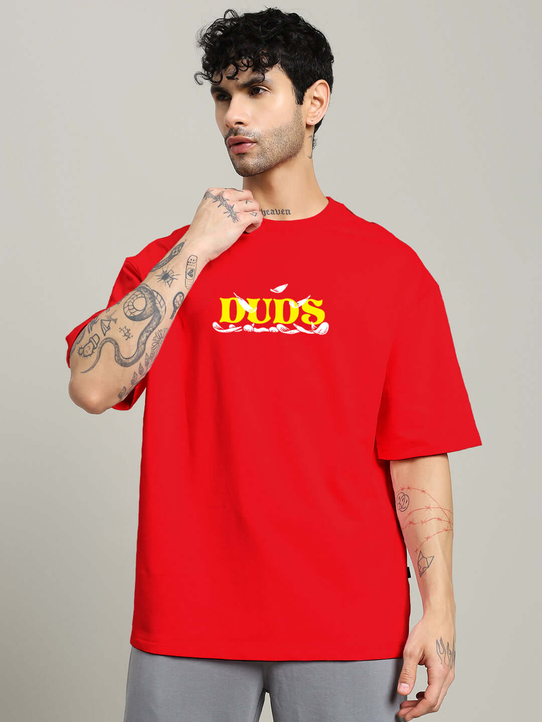 Man wearing vibrant red STAY HAPPY PRINTED OVERSIZED T-SHIRT RED with fun graphic design.