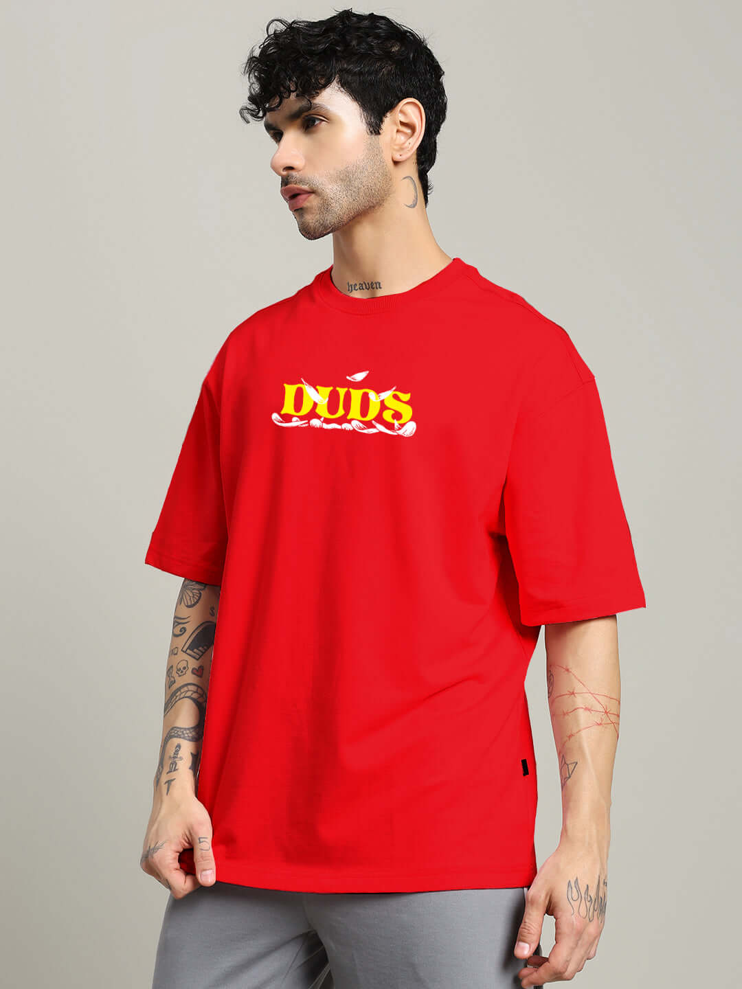 Man wearing STAY HAPPY PRINTED OVERSIZED T-SHIRT RED with graphic design.