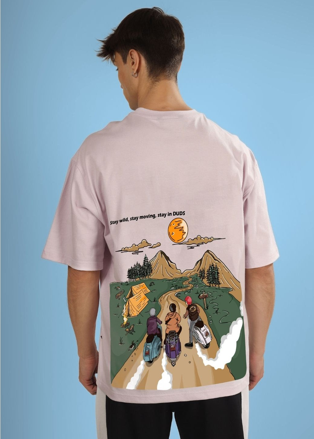 Back view of a person wearing a STAY WILD OVERSIZED T-SHIRT GREY featuring an adventurous graphic print.