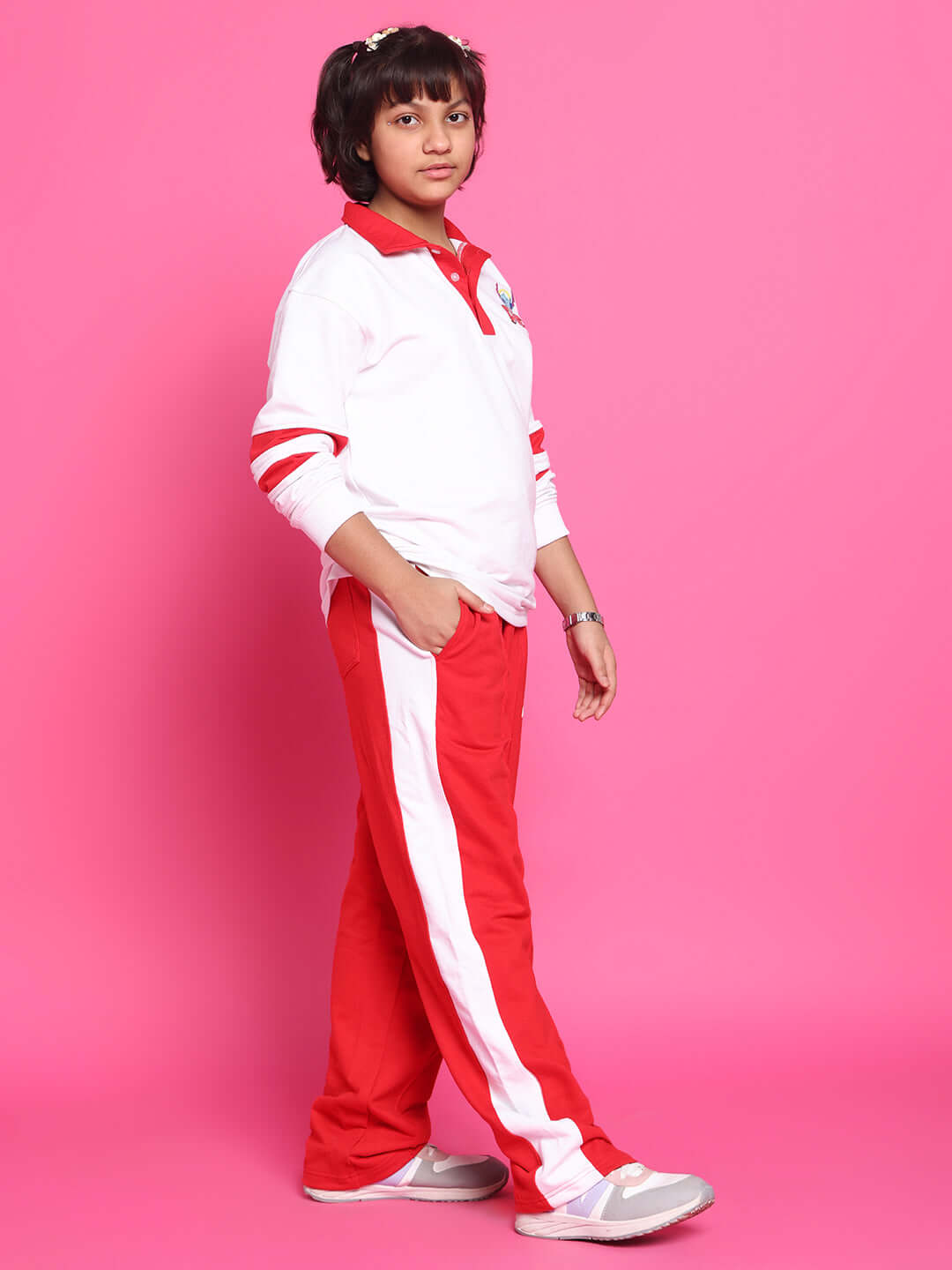 Child wearing STITCH OVERSIZED CO-ORD SET FOR BOYS GIRLS WHITE RED with oversized sweatshirt and joggers on a pink background.