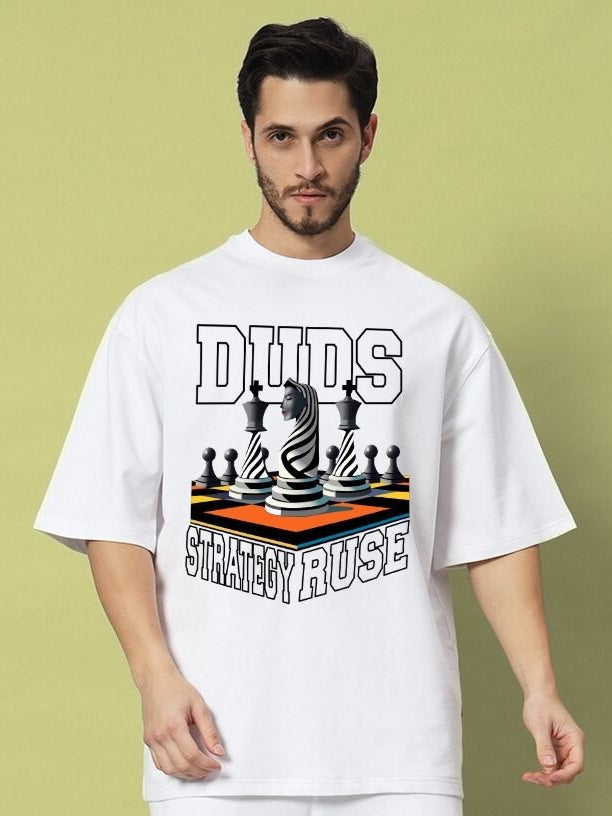 Man wearing STRATEGY RUSE OVER-SIZED T-SHIRT WHITE featuring chess design on front.