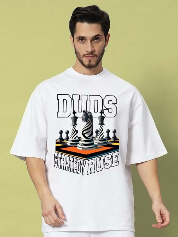 Man wearing STRATEGY RUSE OVER-SIZED T-SHIRT WHITE with chess graphic print, minimalistic streetwear fashion.