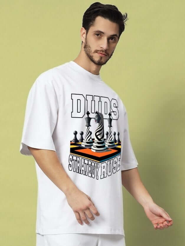 Man wearing STRATEGY RUSE OVER-SIZED T-SHIRT WHITE with chess graphic print
