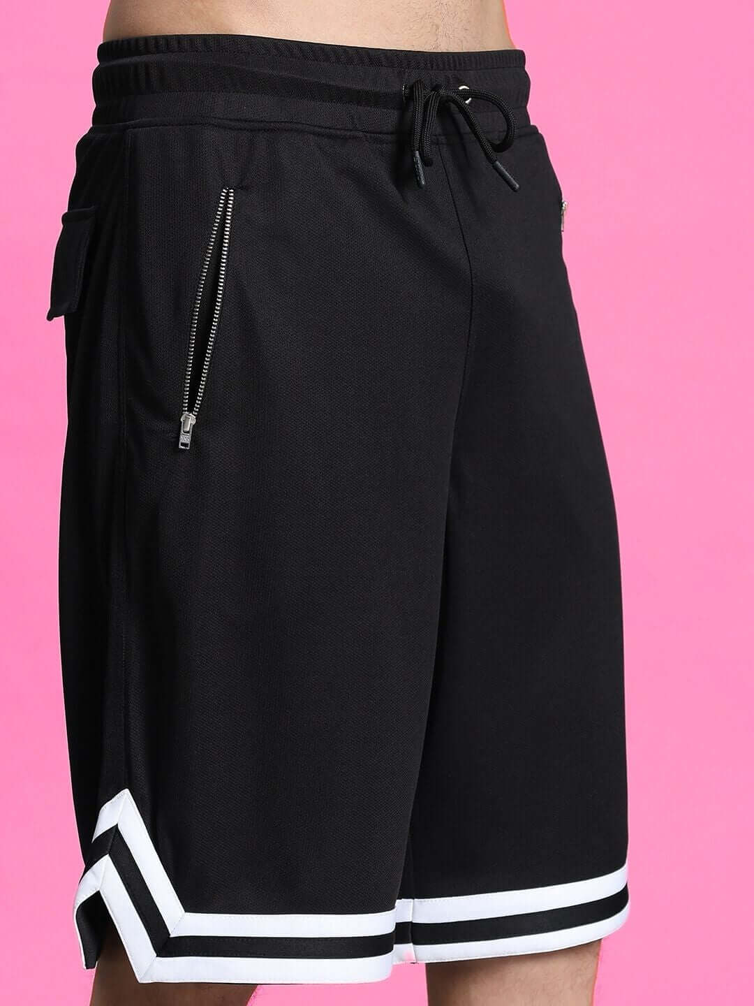 Black Streak Regular Fit Shorts with white trim and zip pockets against a pink background. Custom fit option available for prepaid orders.