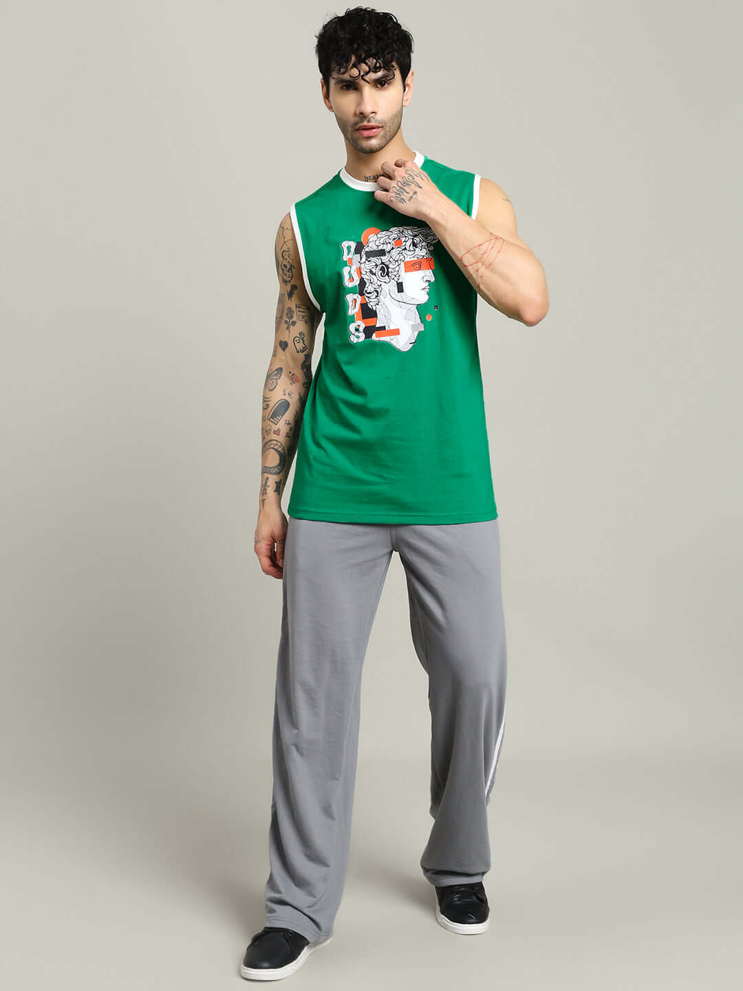 Model wearing STREAM REGULAR FIT T-SHIRT GREEN, casual style with graphic print, showcasing cool urban fashion.