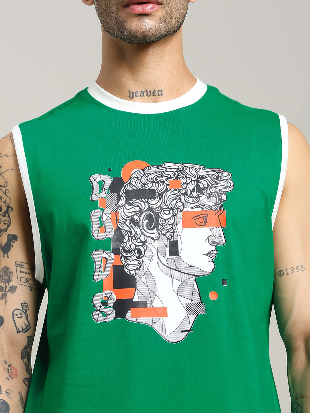 Green sleeveless t-shirt featuring graphic design, worn by tattooed male model, exemplifies STREAM REGULAR FIT T-SHIRT GREEN.