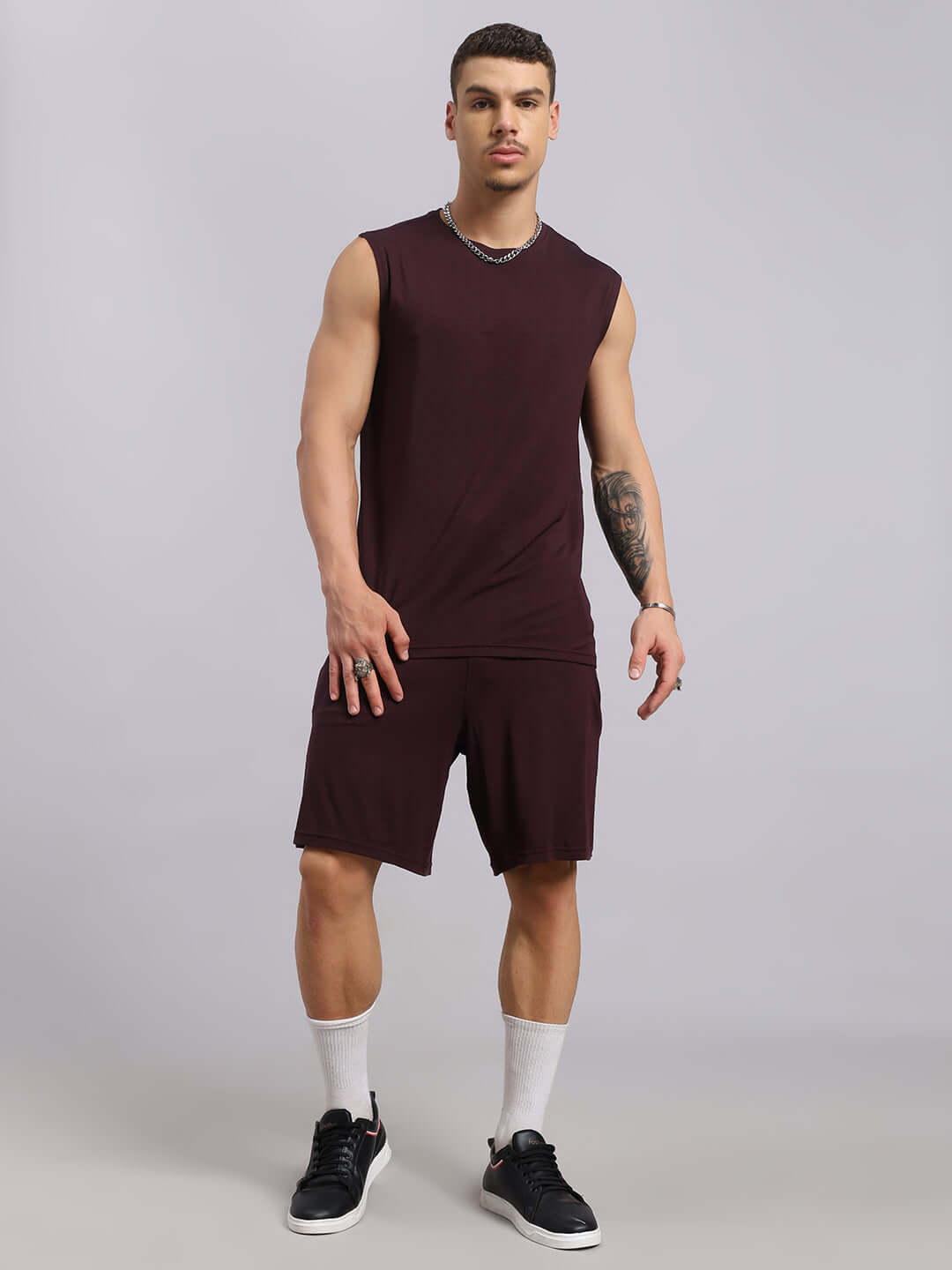 STRENGTH FREAK CO-ORD SET in wine color, premium heavy gauge modal fabric. Model wearing the sleeveless top and shorts standing.