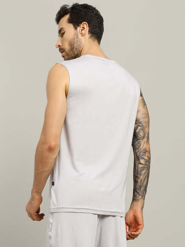 Man wearing STRENGTH FREAK FITNESS T-SHIRT LIGHT GREY, back view, tattooed arm