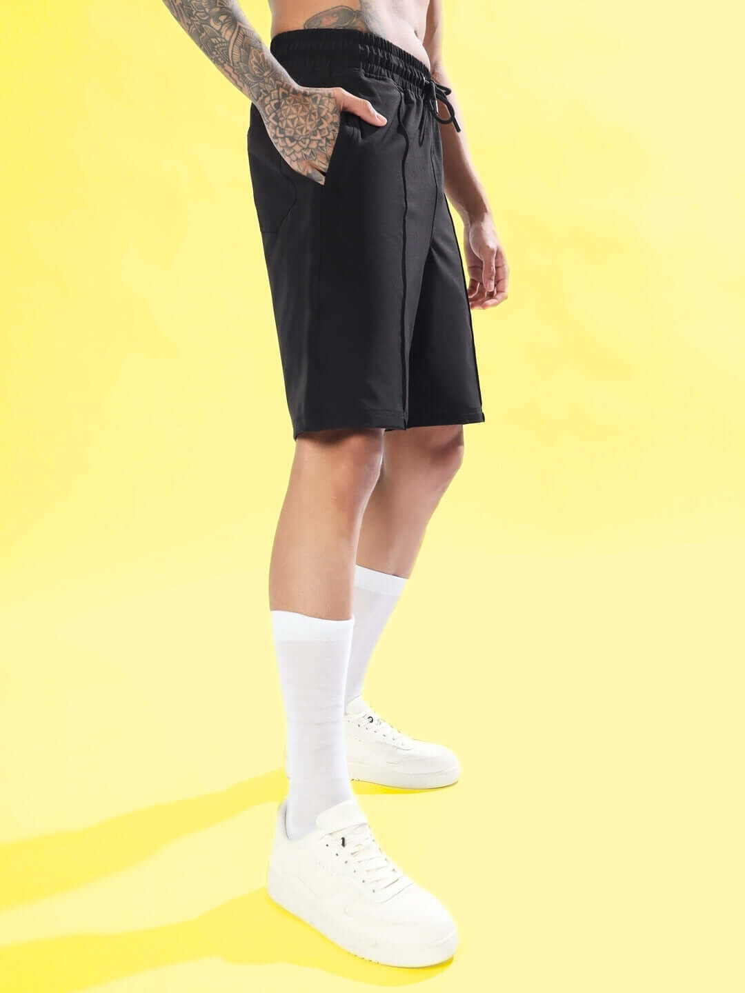 Black sturdy front plated shorts on a model, highlighting athletic fit and comfort.