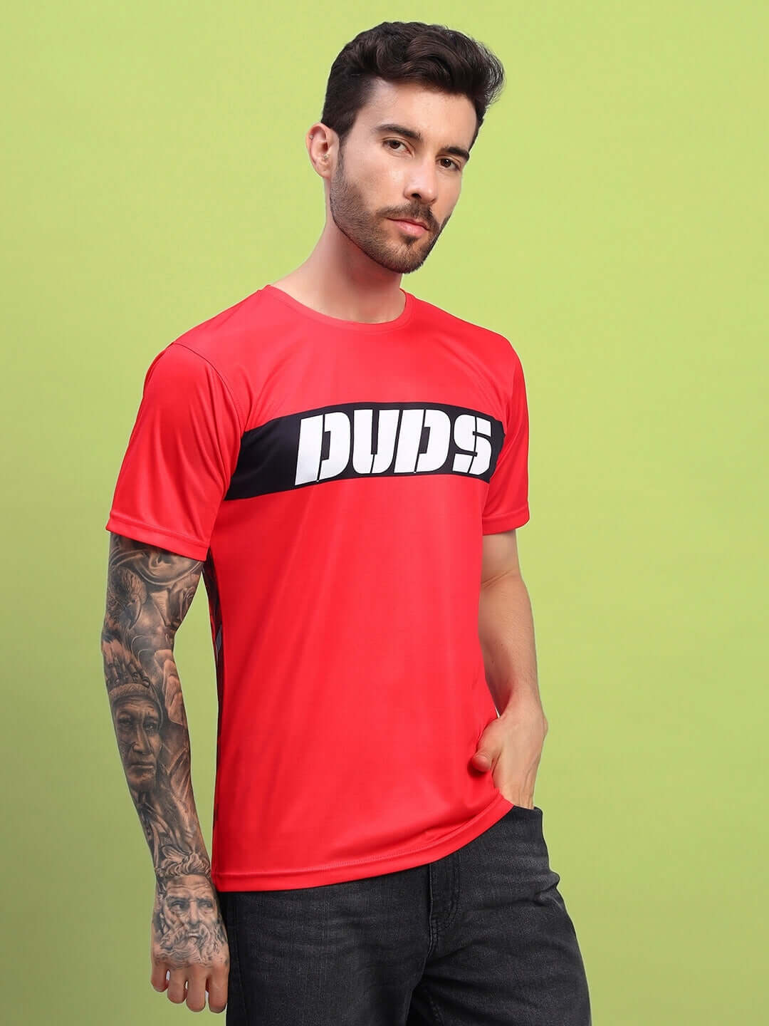 Model wearing red sports T-shirt with 'DUDS' logo, styled for casual look