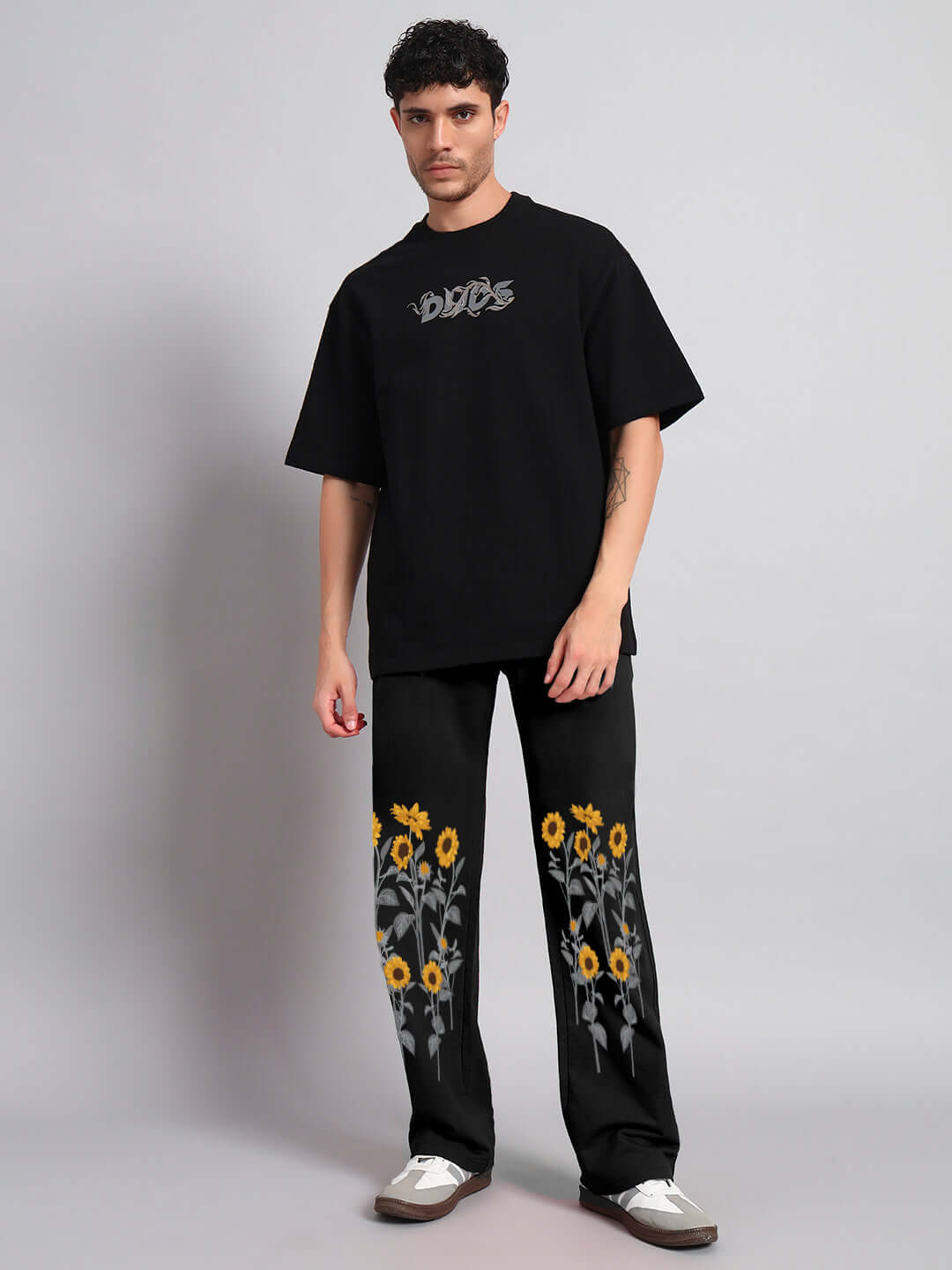 Model wearing Sunflower Relaxed-Fit Jogger Black with sunflower detailing, showcasing relaxed style and comfortable fit.