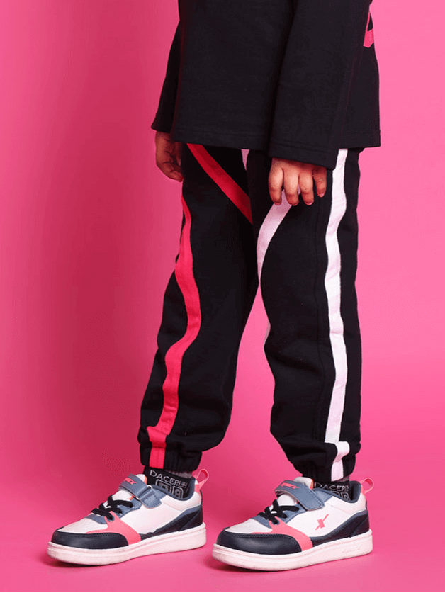 Child wearing black SUPER CHAMP co-ord set with pink stripes, premium cotton French terry fabric, suitable for boys and girls.