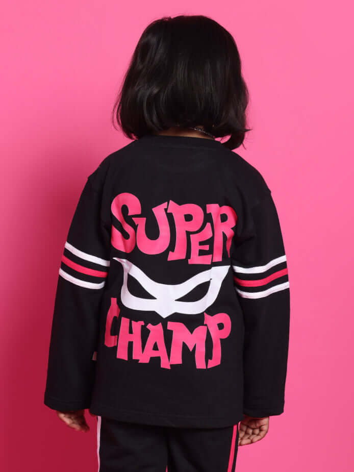 Child wearing SUPER CHAMP OVER-SIZED SWEATSHIRT FOR BOYS GIRLS BLACK with bold pink text and stripes on a pink background.