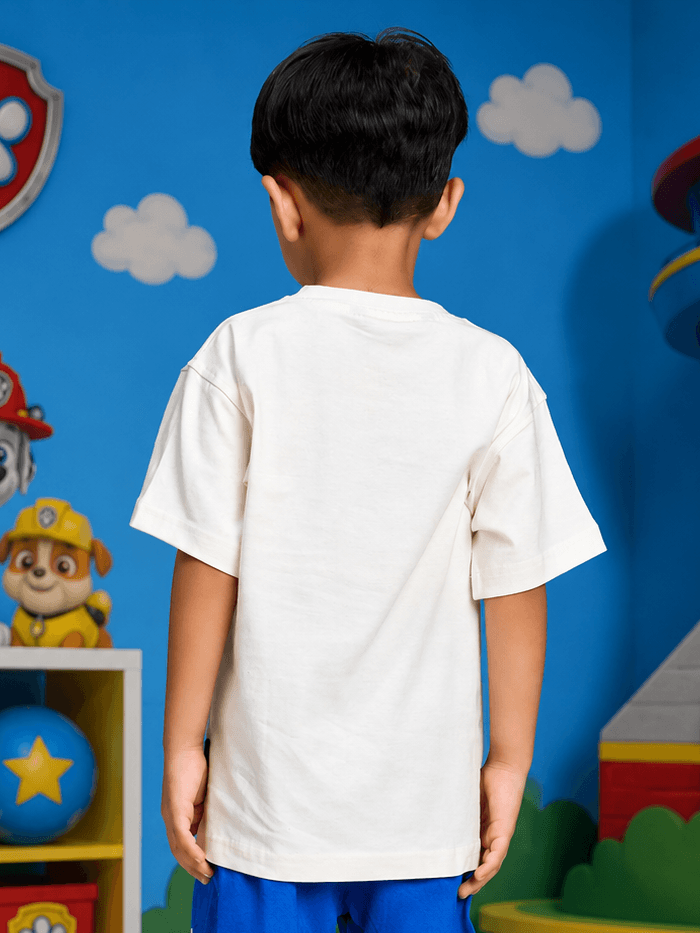 Back view of a child wearing a SUPER SQUAD T-SHIRT FOR BOYS GIRLS WHITE in a colorful playroom.