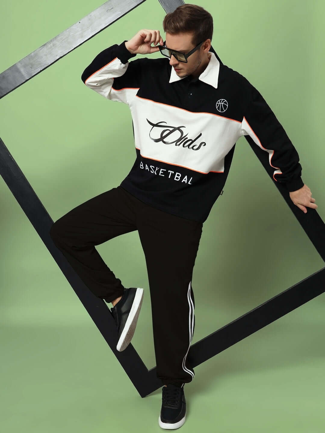 Model wearing black relaxed pant jogger from DUDS, styled with a sporty top, showcasing casual and athletic fashion.