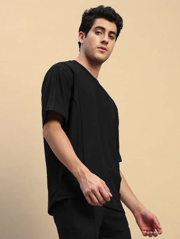 Alt Tag: Model wearing SUPERIOR OVER SIZED T-SHIRT BLACK, showcasing relaxed fit and premium cotton-blend fabric for ultimate comfort.