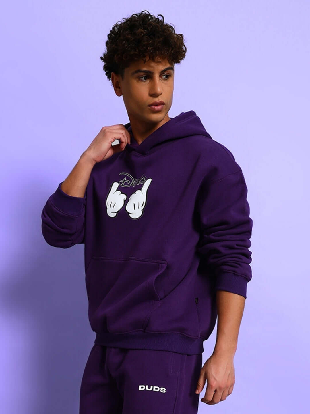 Young man wearing SUPREME COTTON FLEECE HOODIE PURPLE, showcasing premium comfort and bold color in streetwear fashion.