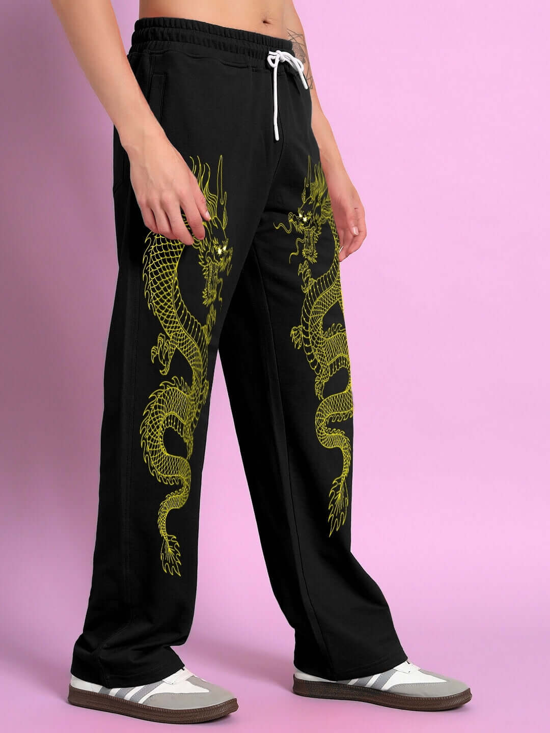 SUPREME DRAGON PRINTED RELAXED FIT JOGGER BLACK featuring a bold dragon design on the sides, styled by a model against a pink background.