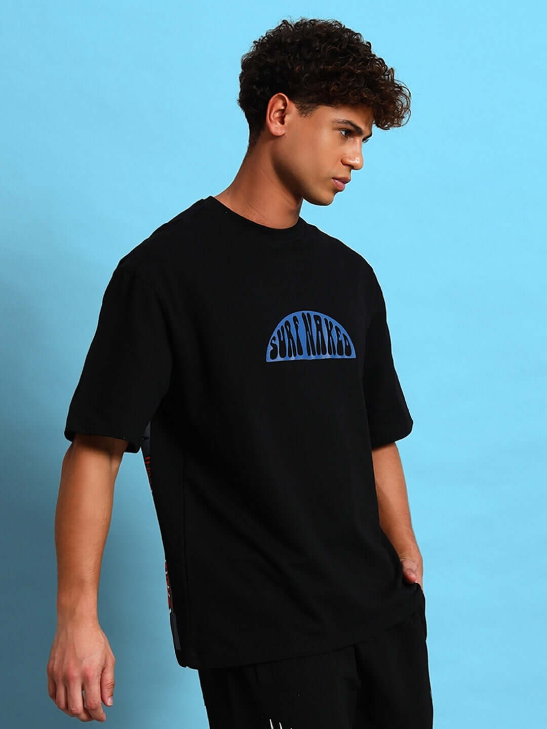 Model wearing Surf Naked Over-Sized T-Shirt Black, featuring relaxed silhouette in high-quality cotton for streetwear style.