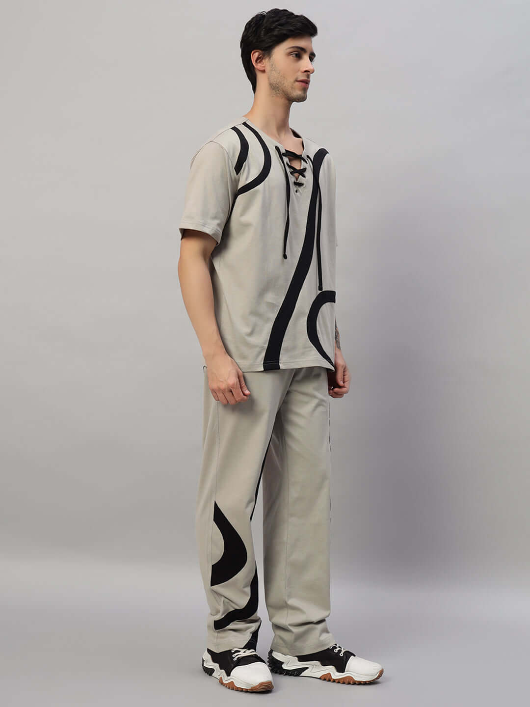 Model wearing SURFING OVERSIZED CO-ORD SET GREY with relaxed fit joggers and elasticated waistband featuring contrast panels.
