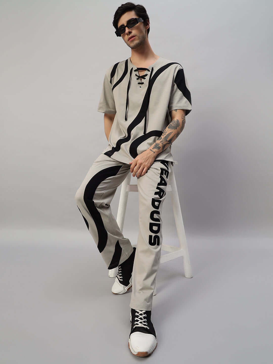 Model wearing grey SURFING OVERSIZED CO-ORD SET with relaxed fit joggers and elastic waistband with drawstring, featuring unique design.