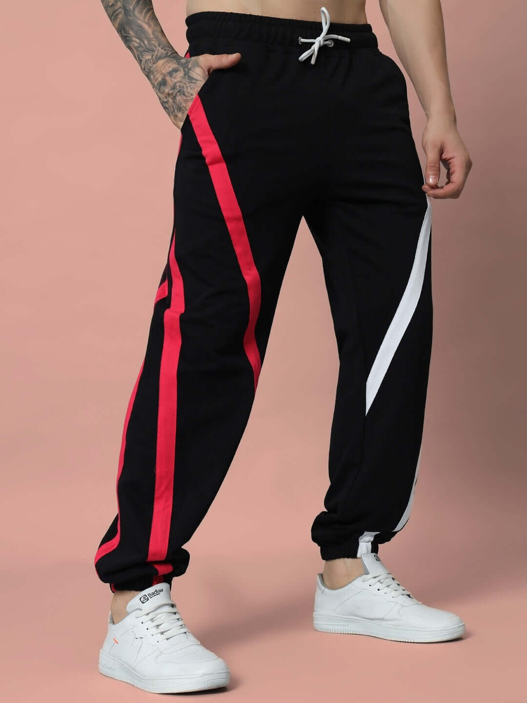 Model wearing Swathe Colorful Stripe Joggers in black with red and white accents, featuring a relaxed fit and drawstring waistband.