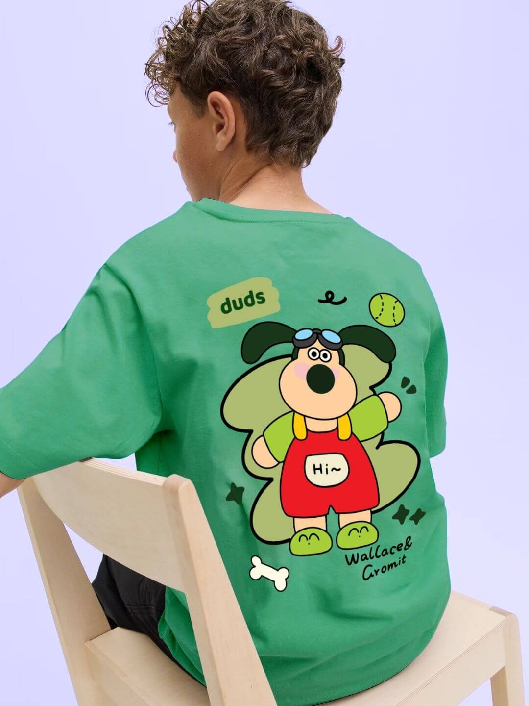 Child wearing TADDY PUPPY T-SHIRT FOR BOYS AND GIRLS GREEN with playful puppy design on back.