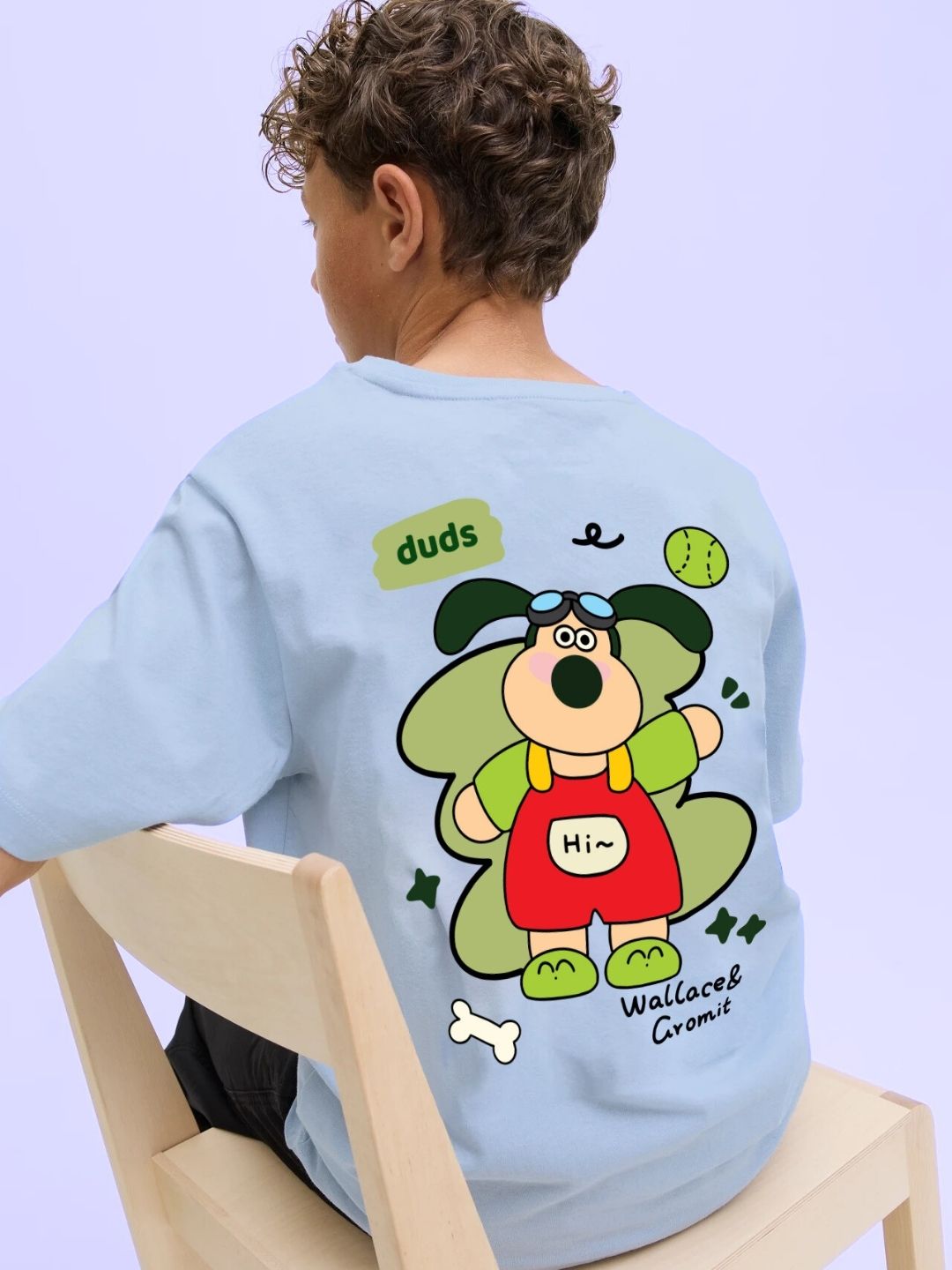 TADDY PUPPY T-SHIRT FOR BOYS AND GIRLS SKY BLUE with cartoon design on a child sitting on a chair.