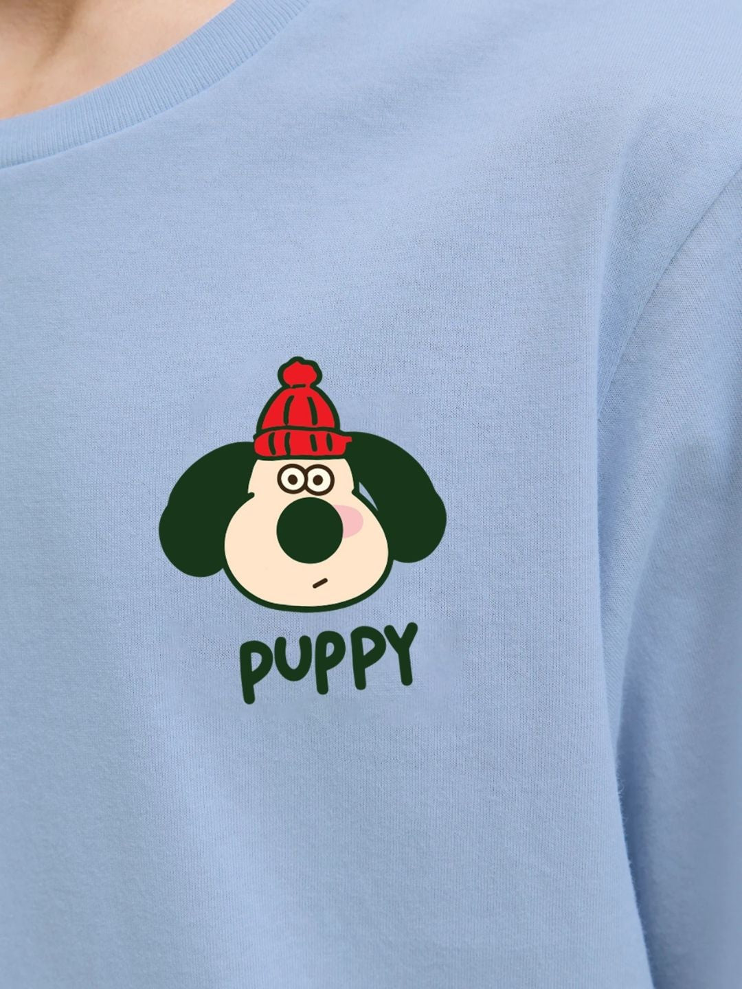 TADDY PUPPY T-SHIRT FOR BOYS AND GIRLS SKY BLUE featuring a cartoon puppy wearing a red hat on a light blue fabric background.