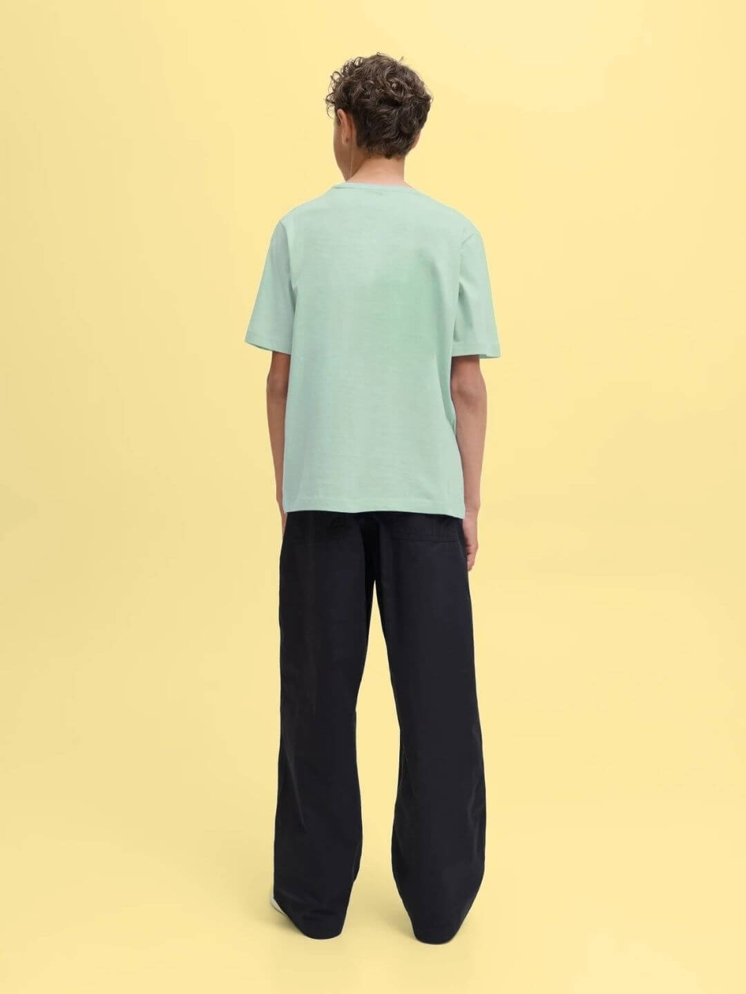 Back view of a child wearing a TARGET PRINTED T-SHIRT FOR BOYS AND GIRLS LIGHT GREEN, showcasing a relaxed fit and a trendy look.