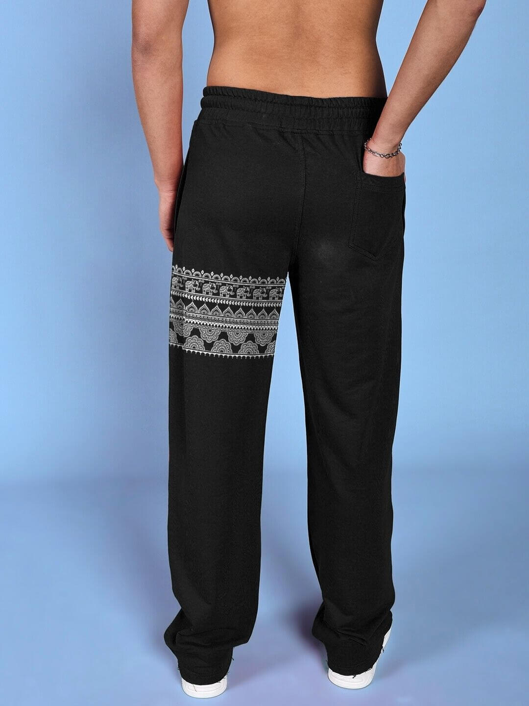 Back view of THAI TRADITIONAL PRINTED RELAXED FIT JOGGER BLACK on model, showcasing intricate Thai patterns.