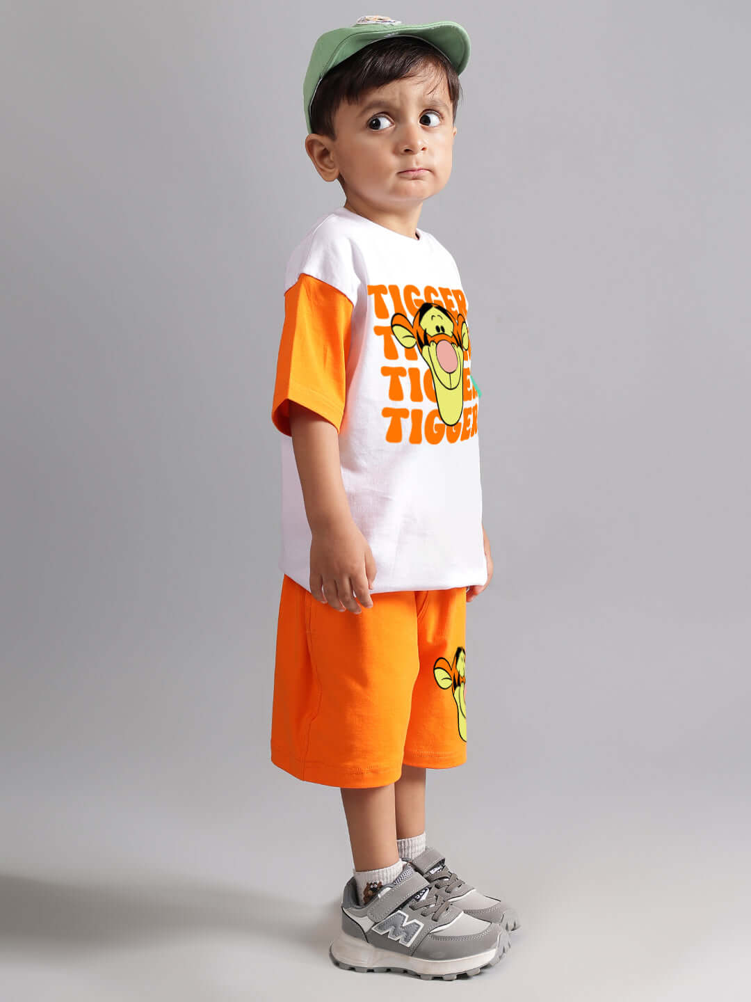 Young child wearing orange TIGER shorts and matching T-shirt set, ideal for boys and girls, with playful design and comfortable fit.
