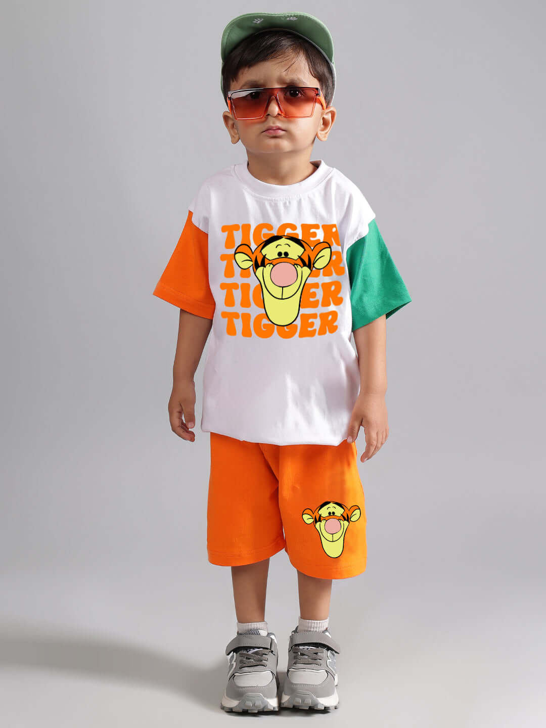 Child wearing orange Tiger shorts and matching t-shirt, showcasing kids' fashion with playful design by DUDS.