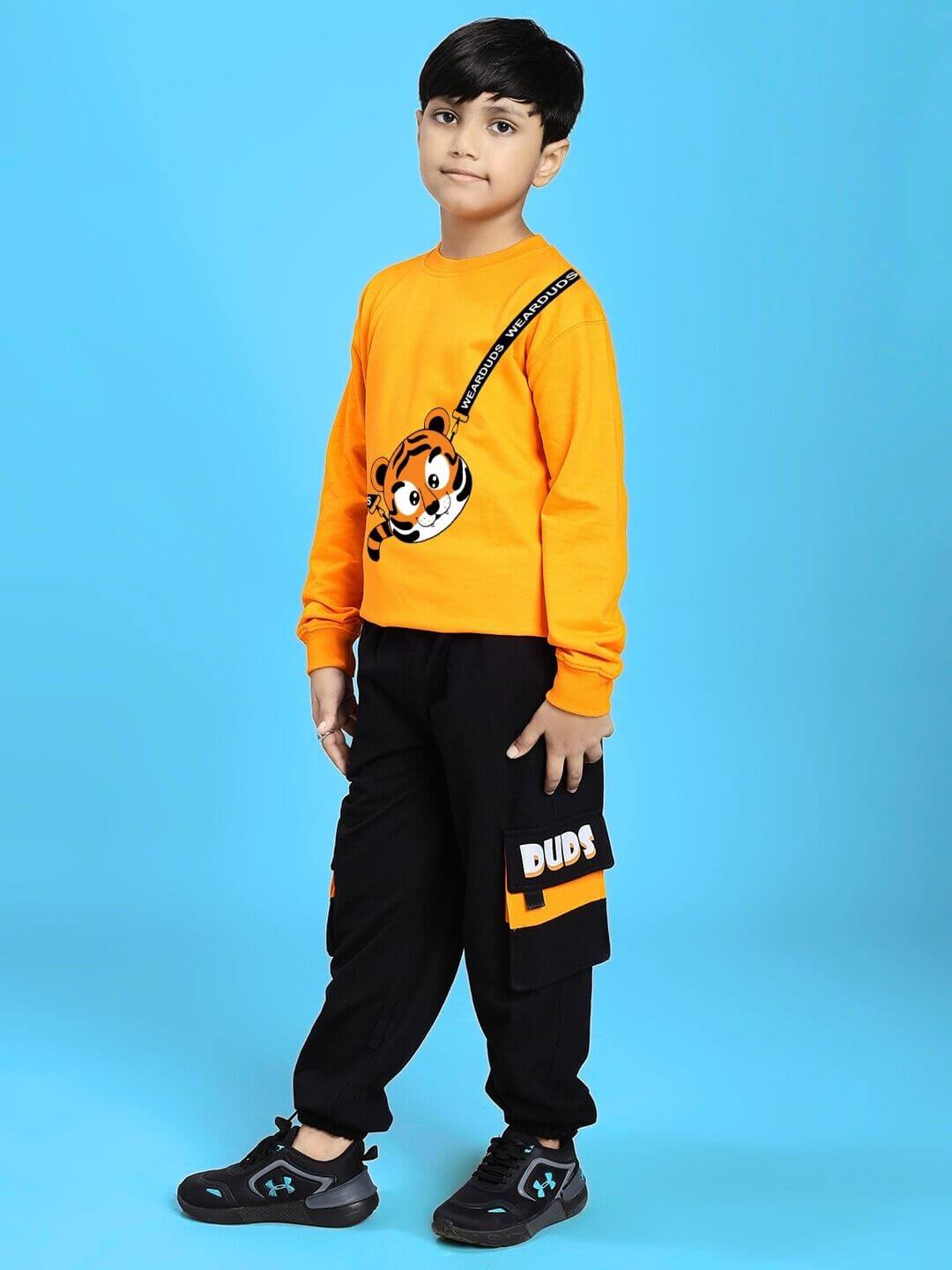 TIGON KIDS CO-ORD SET FOR BOYS AND GIRLS ORANGE BLACK worn by child model against blue background, showcasing stylish outfit.