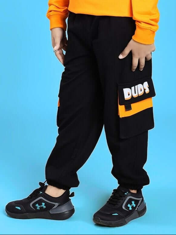 Child wearing TIGON KIDS JOGGER FOR BOYS AND GIRLS RED BLACK with bold design and comfortable fit, showcasing sporty style.