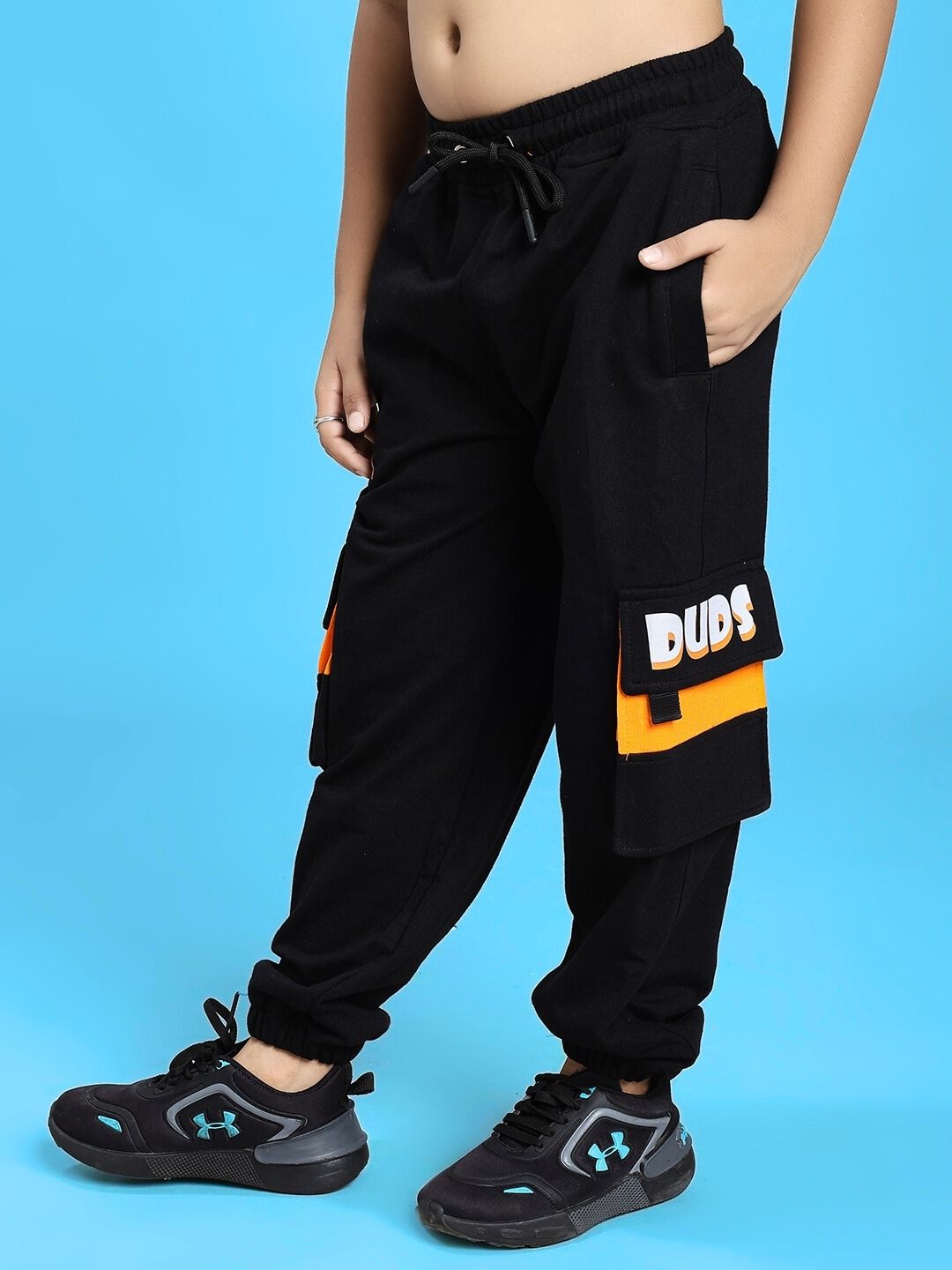 Child wearing TIGON KIDS JOGGER FOR BOYS AND GIRLS RED BLACK, featuring sporty design, comfortable fit, and bold color contrast.