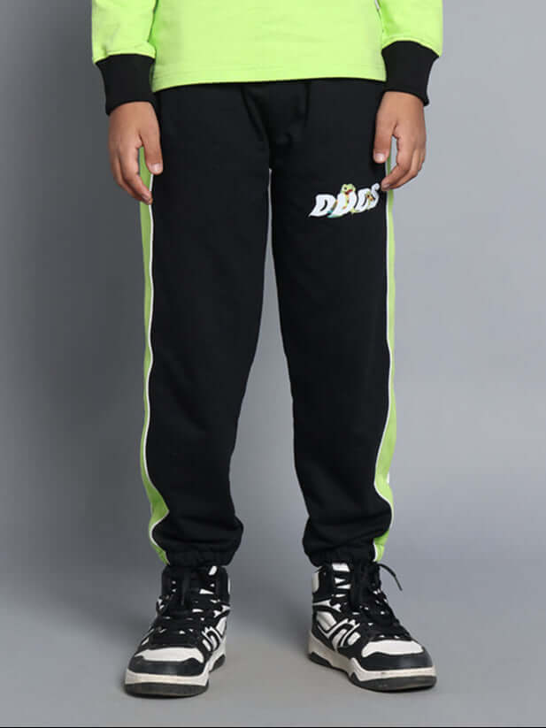 Child wearing TILLY Jogger in black and neon green, showcasing DUDS logo and custom fit option for boys and girls.