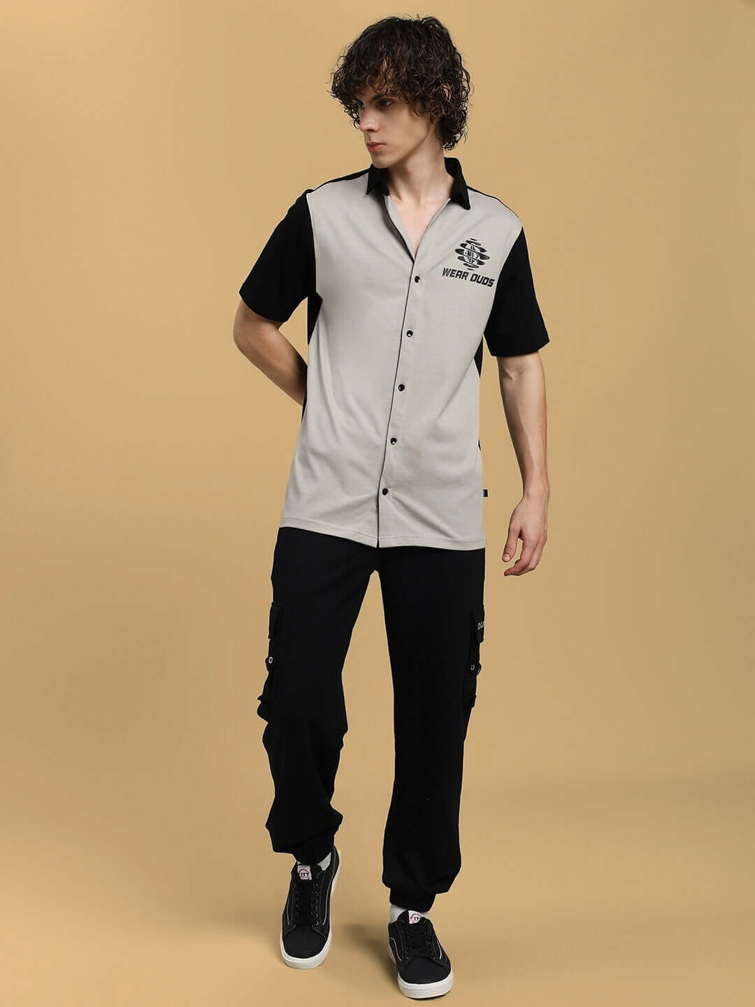 Model wearing TINGE regular fit grey-black shirt, custom fit available, designed by DUDS.