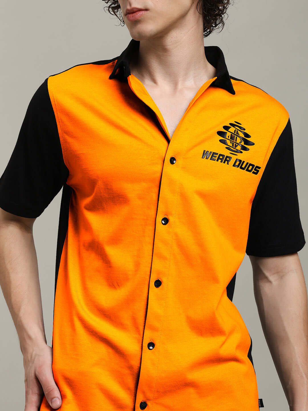 Orange-black Tinge regular fit shirt worn by a model, featuring buttons and a 'Wear Duds' logo on the chest.
