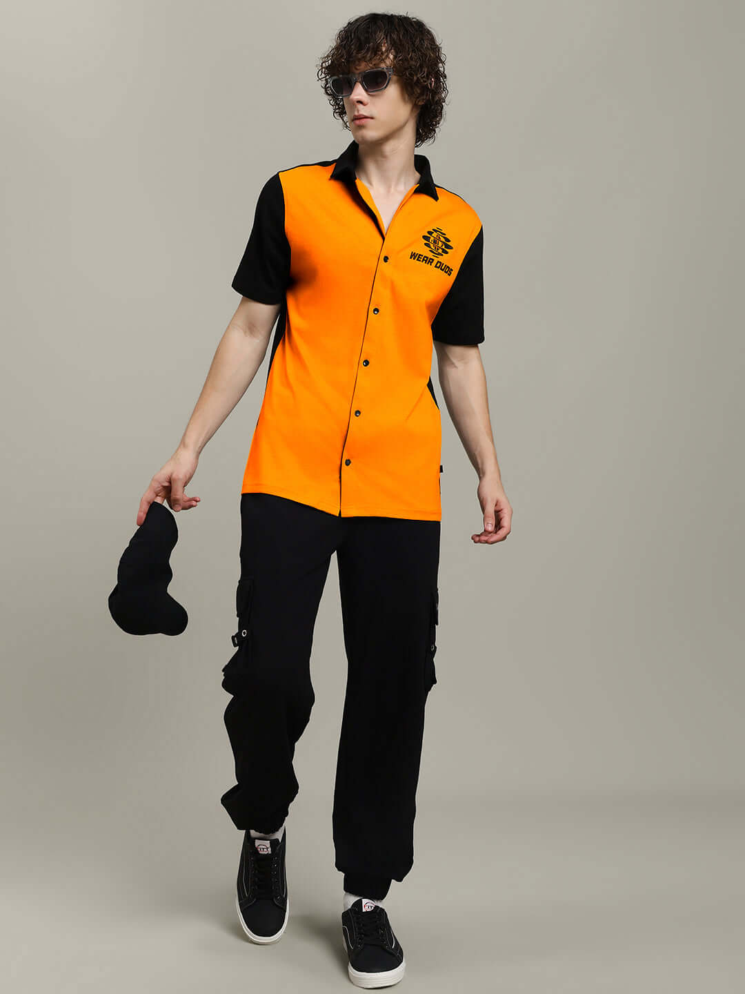 Model wearing Tinge Regular Fit Shirt in orange-black, showcasing fashionable design and style. Available for custom fit with DUDS tailoring.