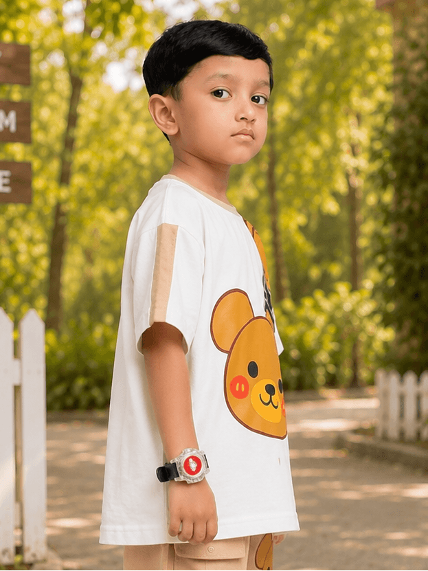 TINY TREND BEAR T-SHIRT FOR BOYS GIRLS WHITE modeled by a boy outdoors, featuring a bear graphic.