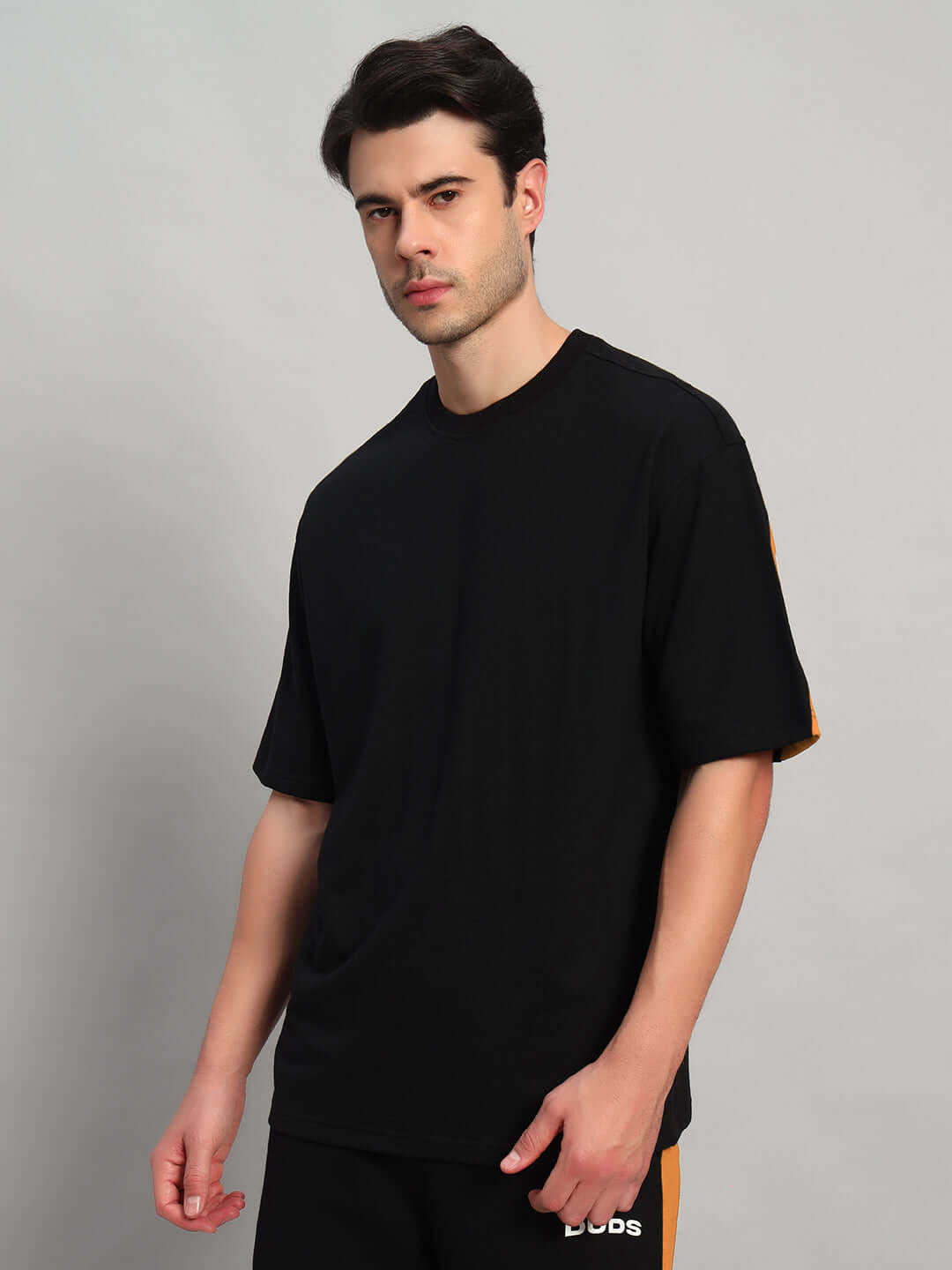 TITAN OVER-SIZED T-SHIRT BLACK-ORANGE made from premium heavy gauge fabric, 97% cotton French terry and 3% elastane, modeling view