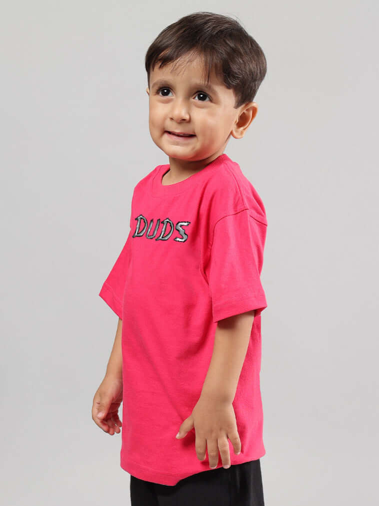 Young child wearing a pink POSITIVE RABBIT T-shirt by DUDS, suitable for boys and girls, available with custom size option.