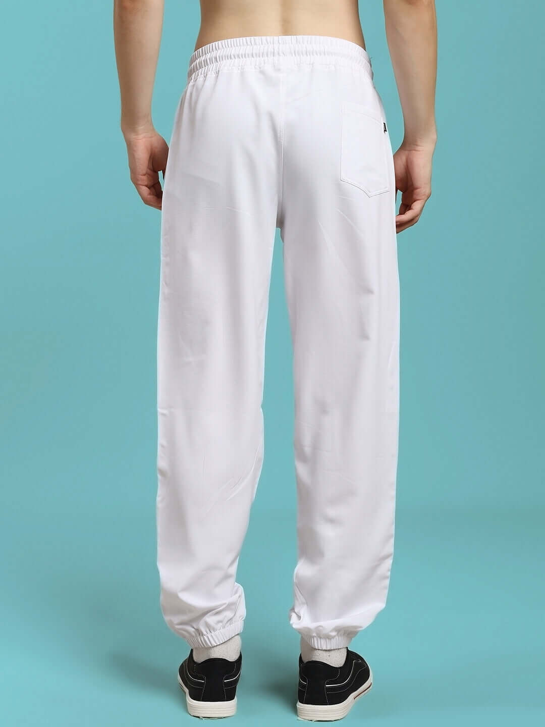 Back view of model wearing TOKYO RELAXED FIT JOGGERS WHITE, showing casual style and comfort.