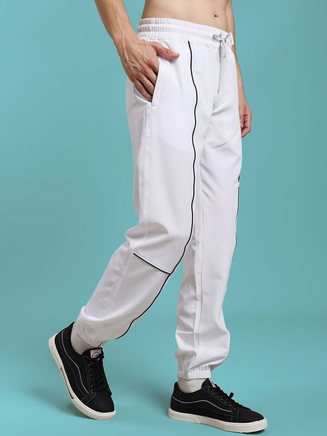 Man wearing TOKYO RELAXED FIT JOGGERS WHITE, showcasing style and comfort.